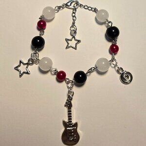 Handmade red, black, and white beaded bracelet with star and guitar charms
